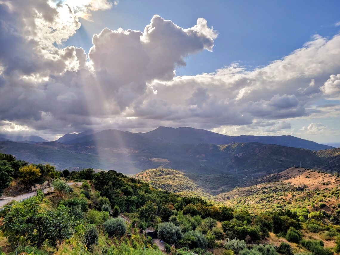 A view of the Madonie Mountains with a streak of sun bursting through the clouds; Pollina, Sicily (Italy)