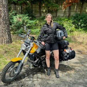 I'm standing in front of a BMW G650 motorcycle while holding my motorcycle helmet gearing up for our long motorcycle ride; Hotel Antonella, Pomezia (Italy)