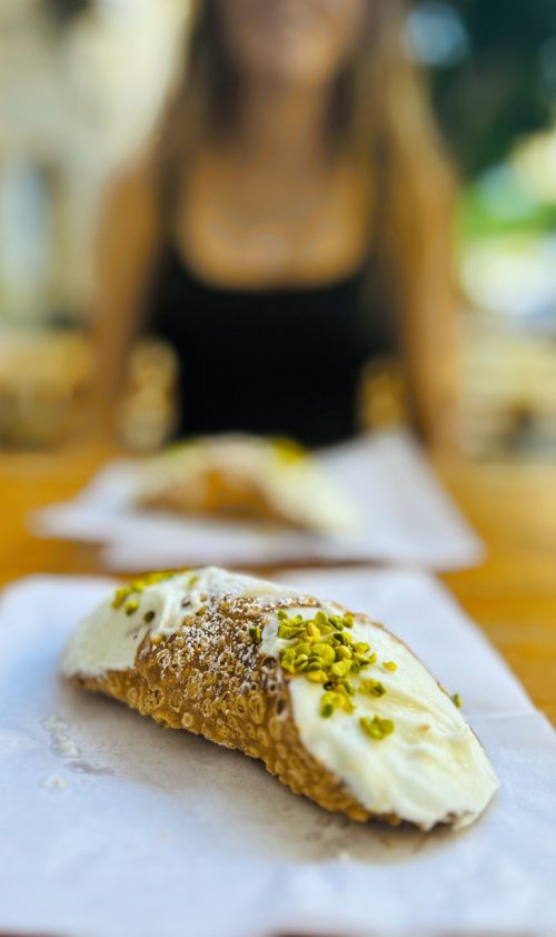 Cannoli with pistachios sprinkled on top with a blurred background @ Oktoberfest Stefanese; Santo Stefano di Camastra, Sicily (Italy)