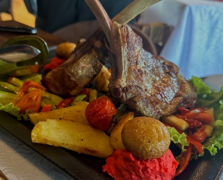 Tomahawk steak dinner on a bed of roasted vegetables @ Maple Restaurant; Novo Brdo, Kosovo