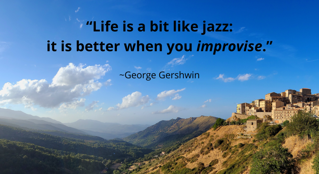 Distant view of the town Geraci Siculo with mountains in the background, and the quote: "Life is a bit like jazz: it is better when you improvise." By: George Gershwin; Geraci Siculo, Sicily (Italy)