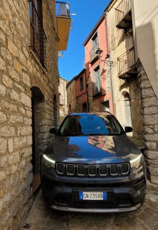 A Jeep Grand Cherokee squeezed into a narrow street; Gratteri, Sicily (Italy)