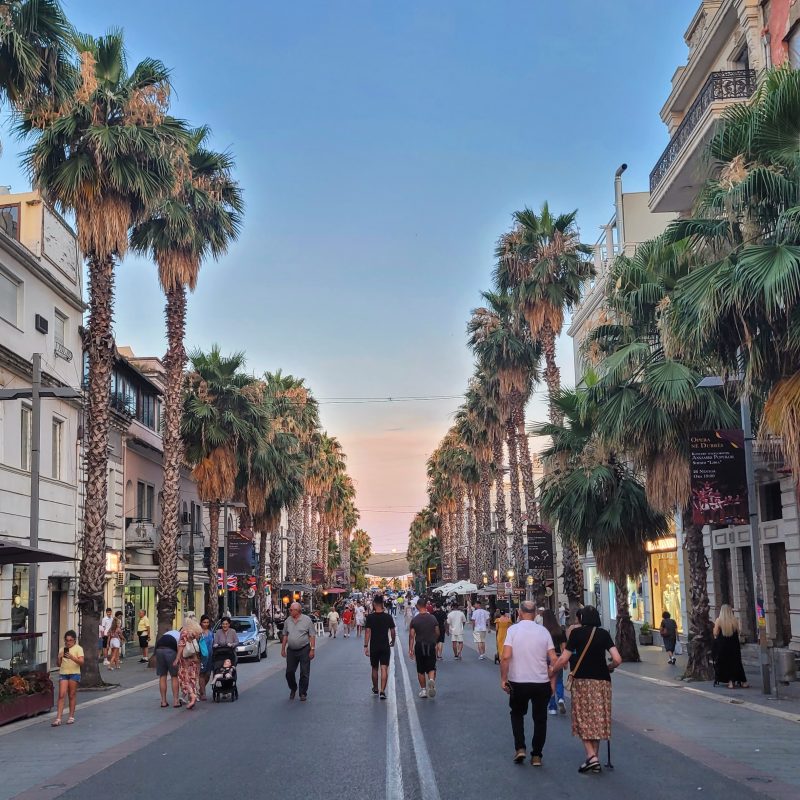 The city is lively with the car-free evening promenades along Epidamn Boulevard as the sun sets in the distance; Durres, Albania