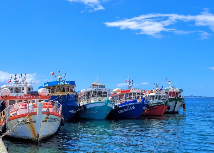 Ferry boats lined up side by side next to the dock; Achao, Quinchao Island (Chile)