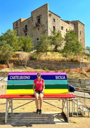 I feel tiny on this giant bench with the Ventimiglia castle in the background; Castelbuono, Sicily (Italy)