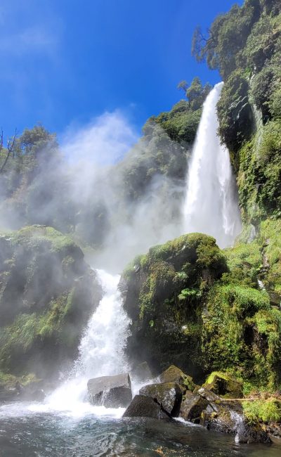 Full length view of the waterfall, Salto El Léon, with the water spraying everywhere; Pucón, Chile