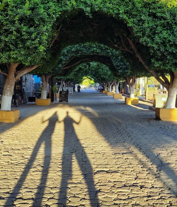 Paul and I are posing for a full body shadow photo as we're enjoying a stroll on the town's cobblestone streets; Loreto, Baja California Sur (Mexico)