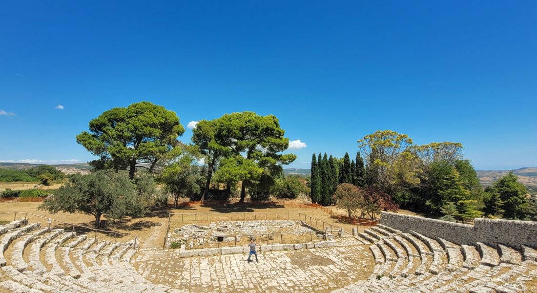 A view at the top of the long set of stairs of the old Greek theater, Teatro di Akrai’ with Paul at the bottom performing a solo act; Palazzolo Acreide, Sicily (Italy)